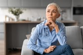 Worried woman at home thinking about retirement