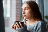 Worried woman drinking a cup of tea