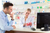 A pharmacist talking to a customer about their prescription medication.