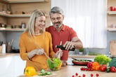 Middle-age couple in kitchen making healthy meal