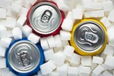 Soda cans surrounded by sugar