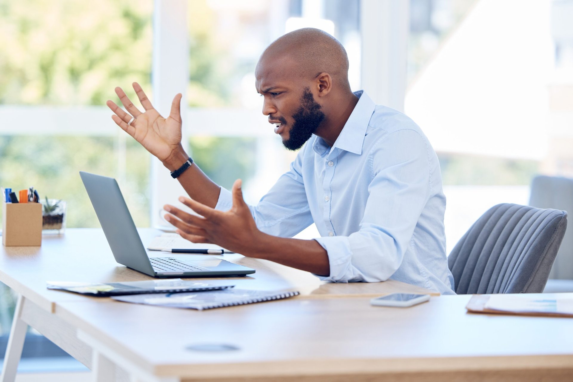 Angry man looking at his laptop