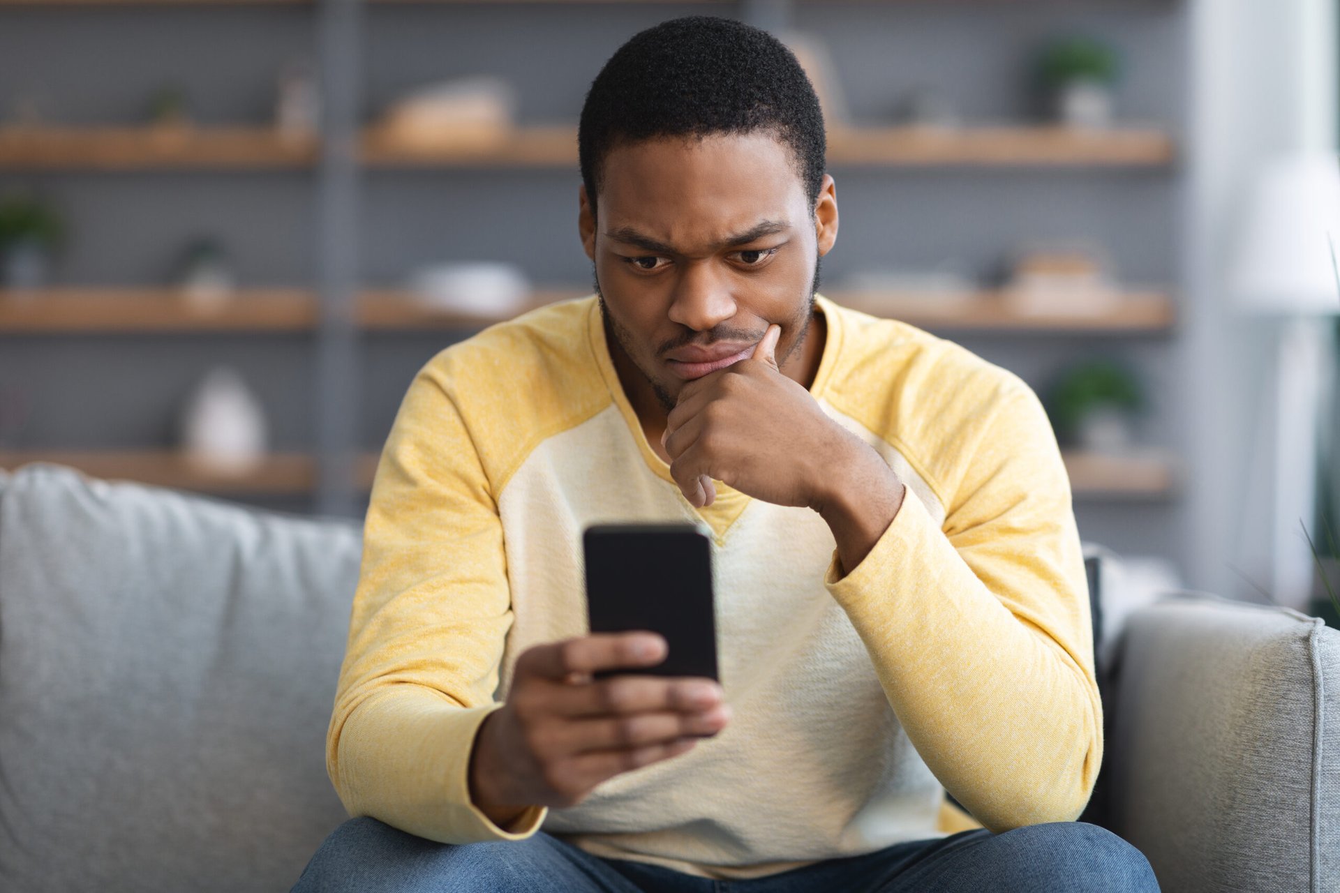 Suspicious man looking at his phone