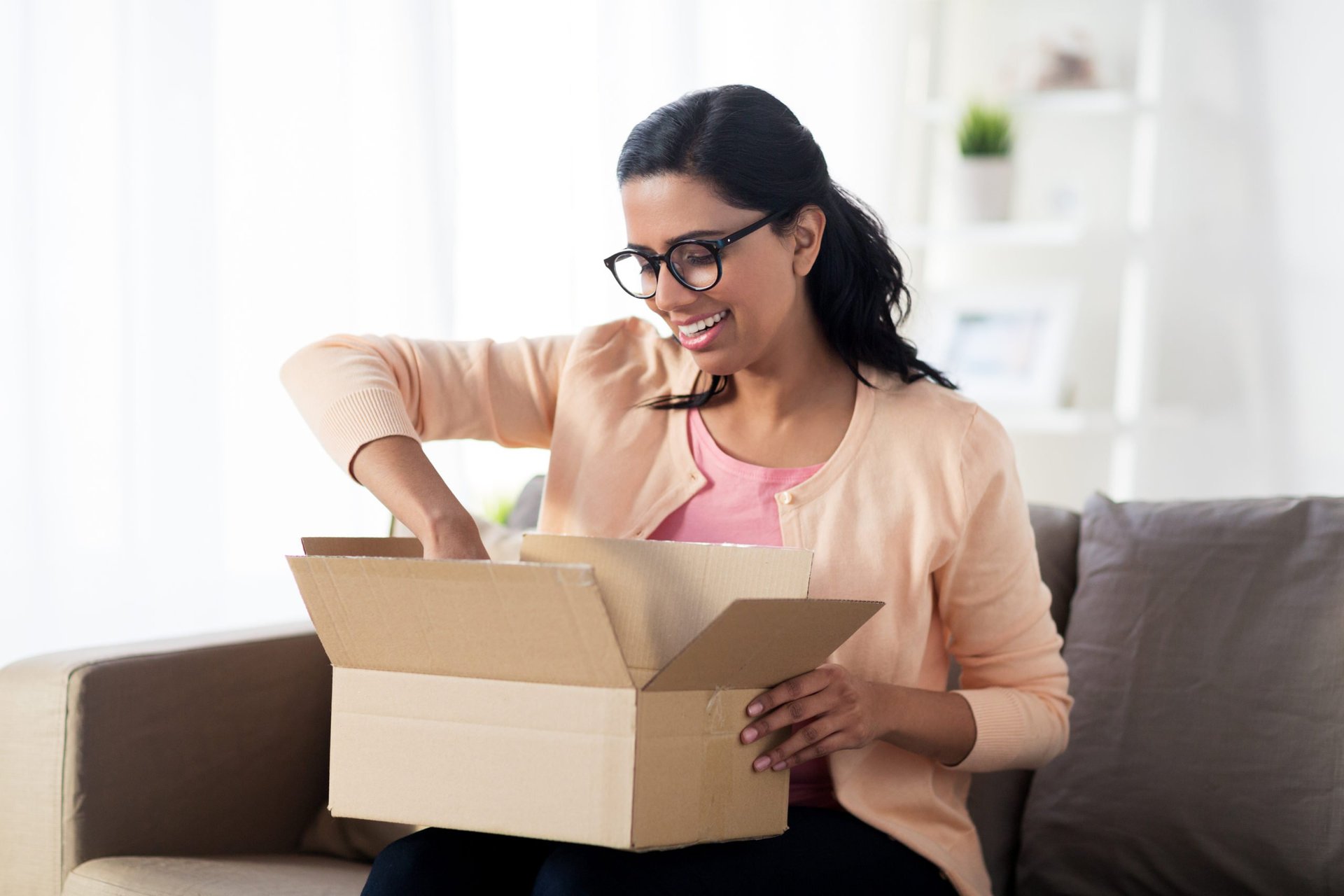 A young woman opens a package she received quickly with overnight shipping