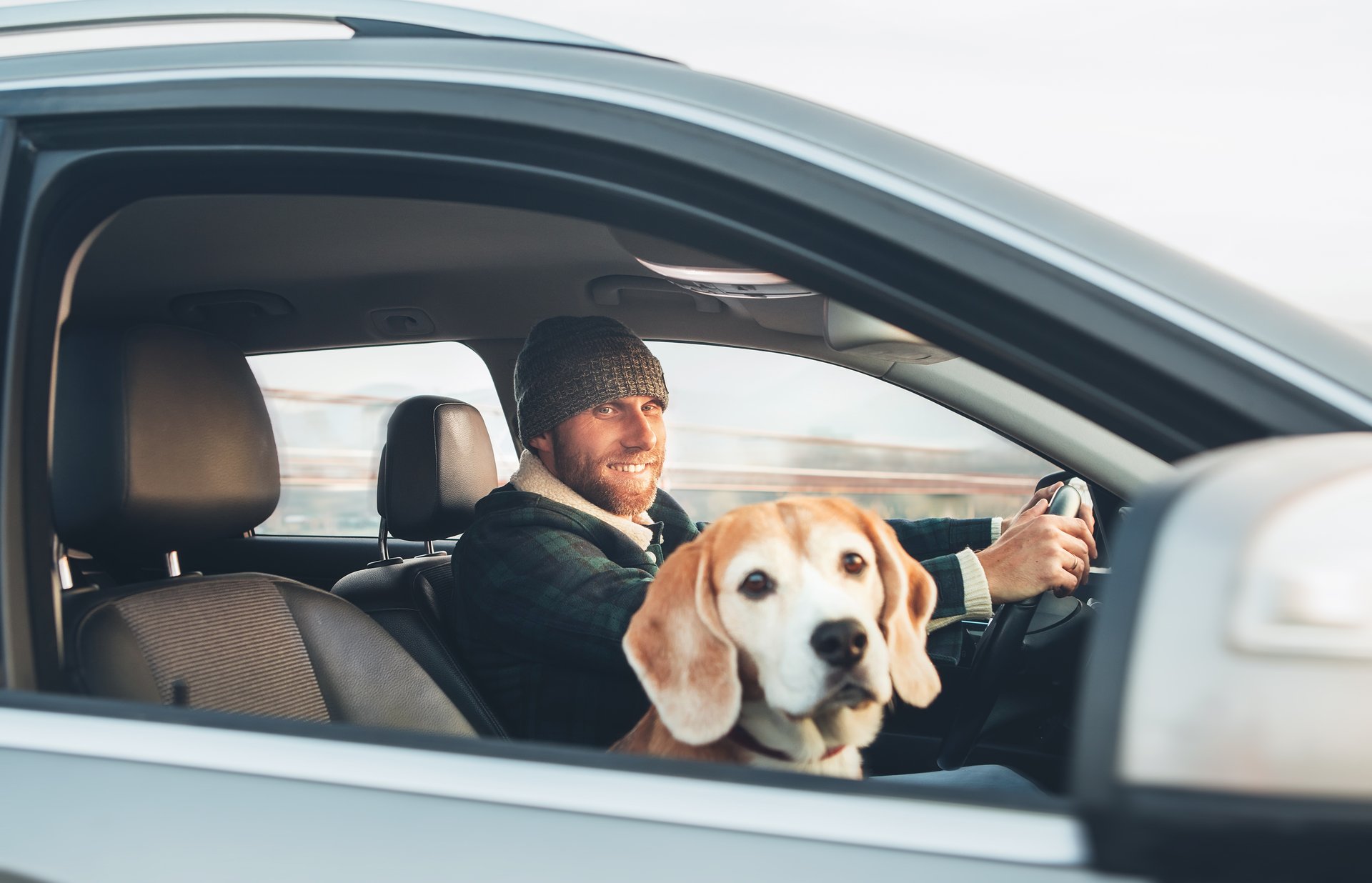 Man driving a car with his dog