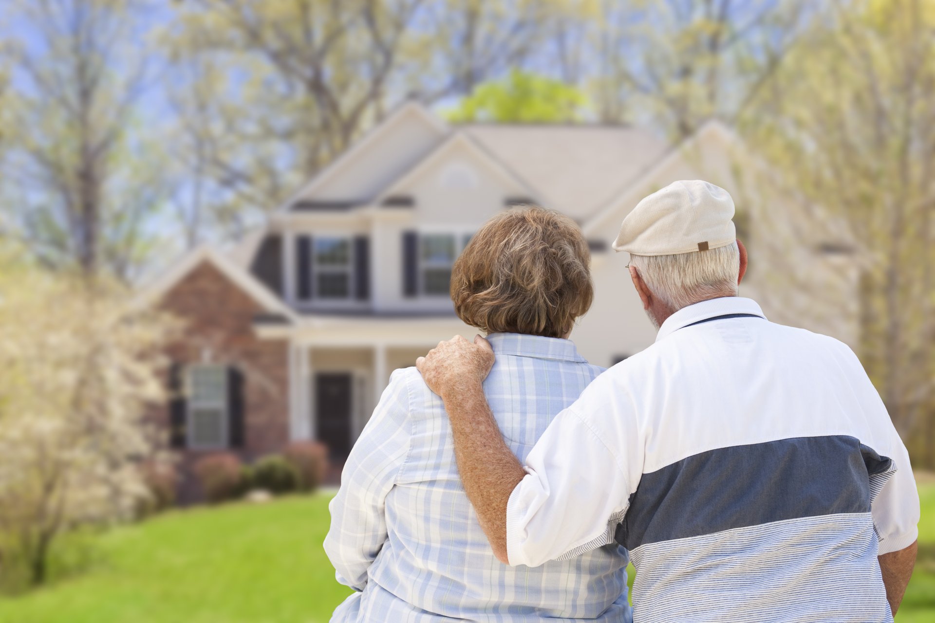 seniors couple man woman backs turned looking at house home