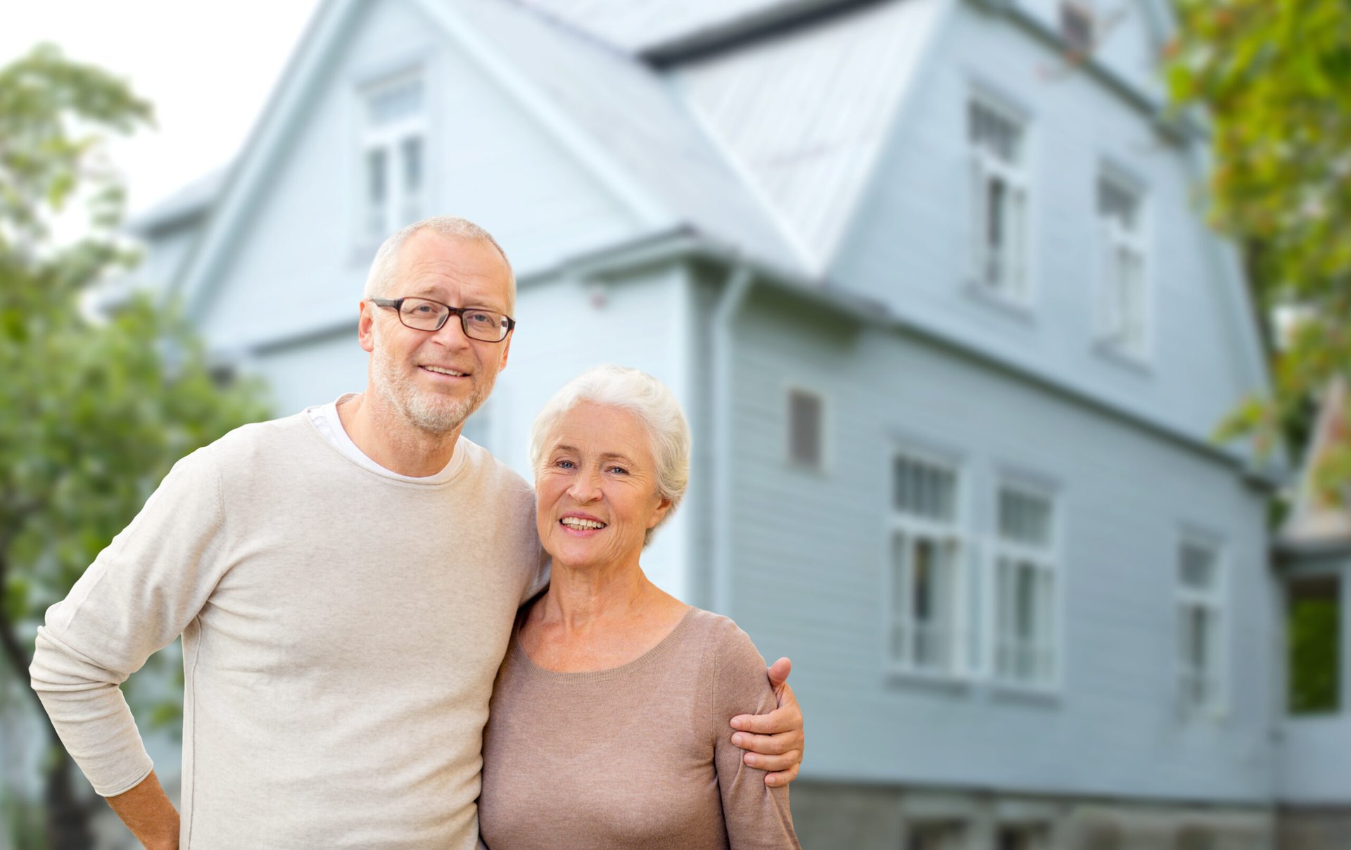 Older couple in front of a house