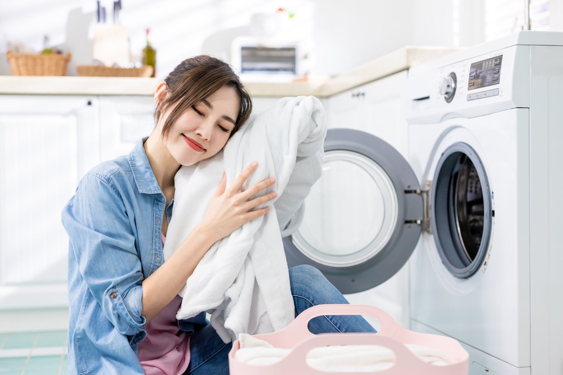 Woman in front of clothes dryer