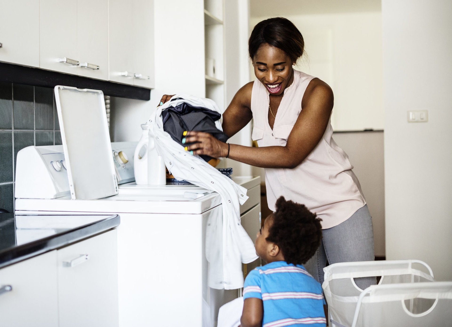 Mother doing laundry with her child