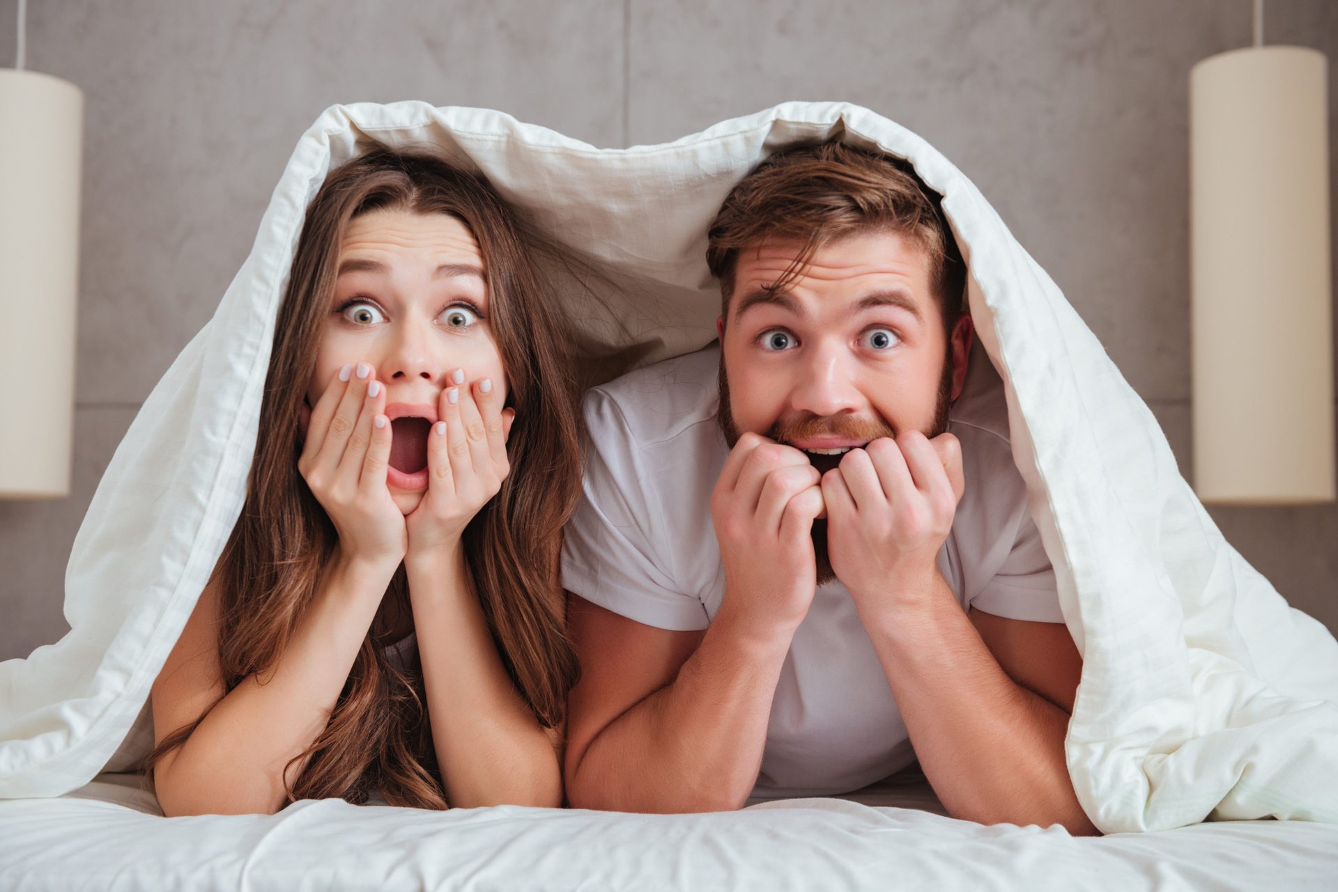 Surprised couple in bed
