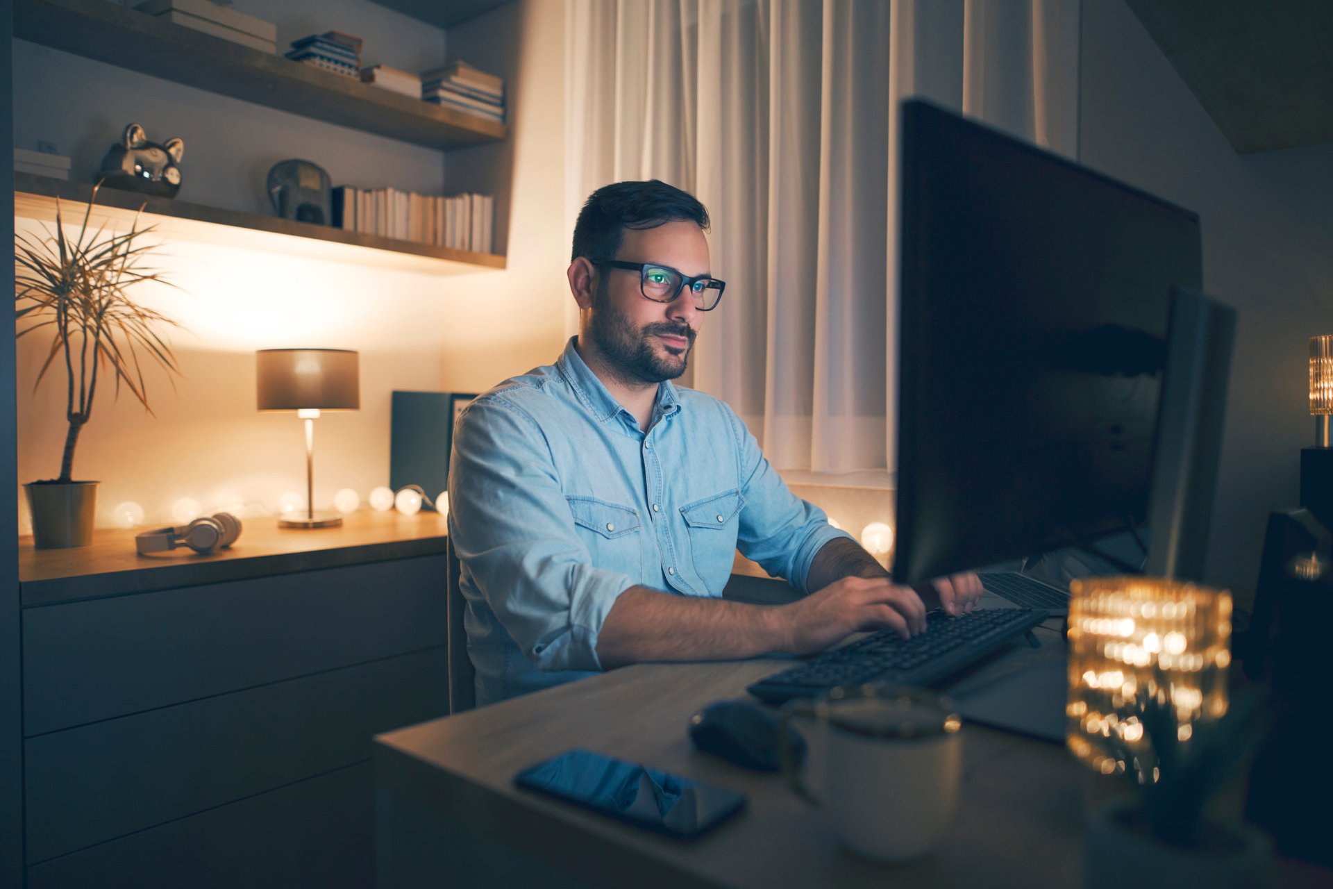 Man working remotely on computer at night