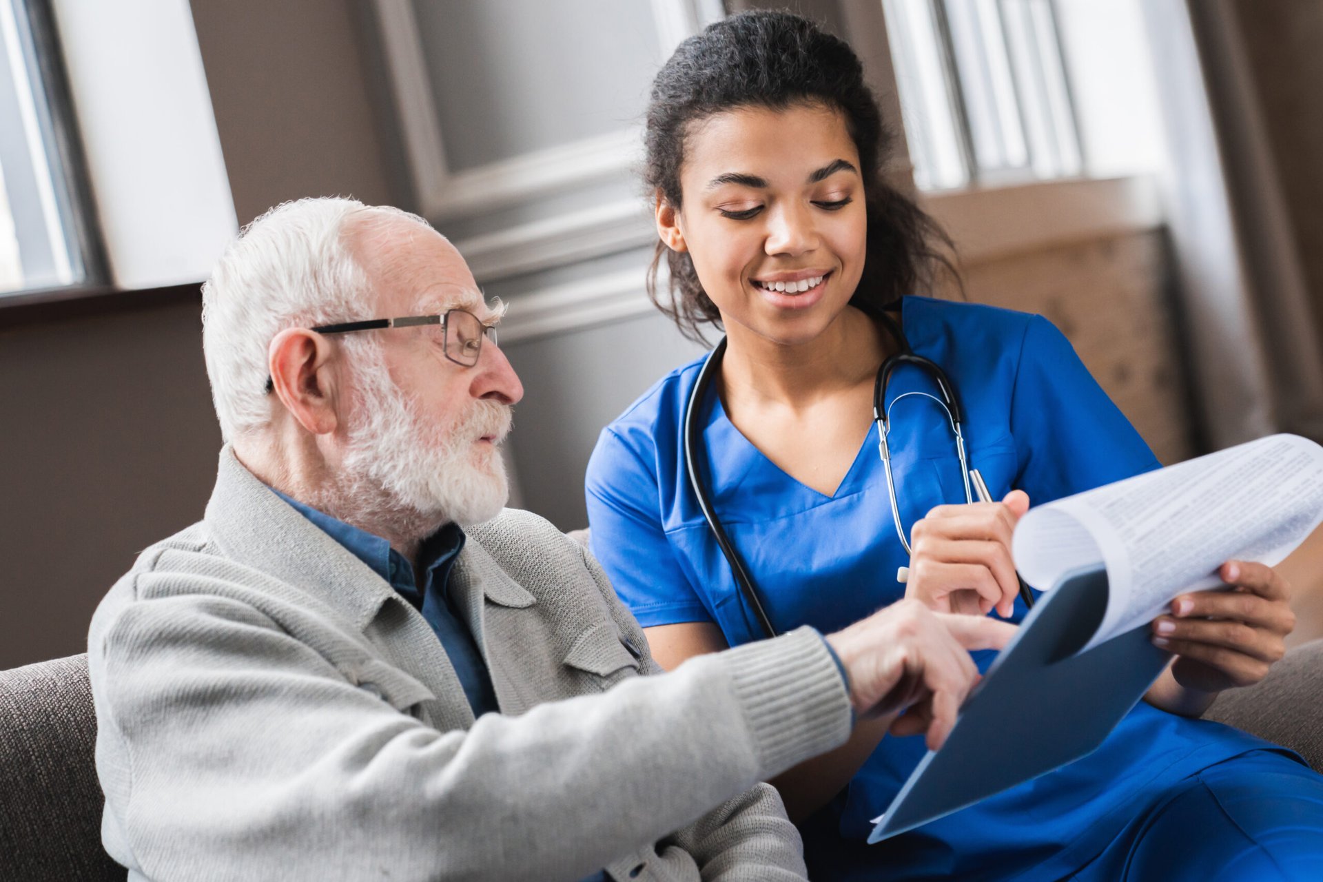 Nurse helping a senior fill out medical paperwork