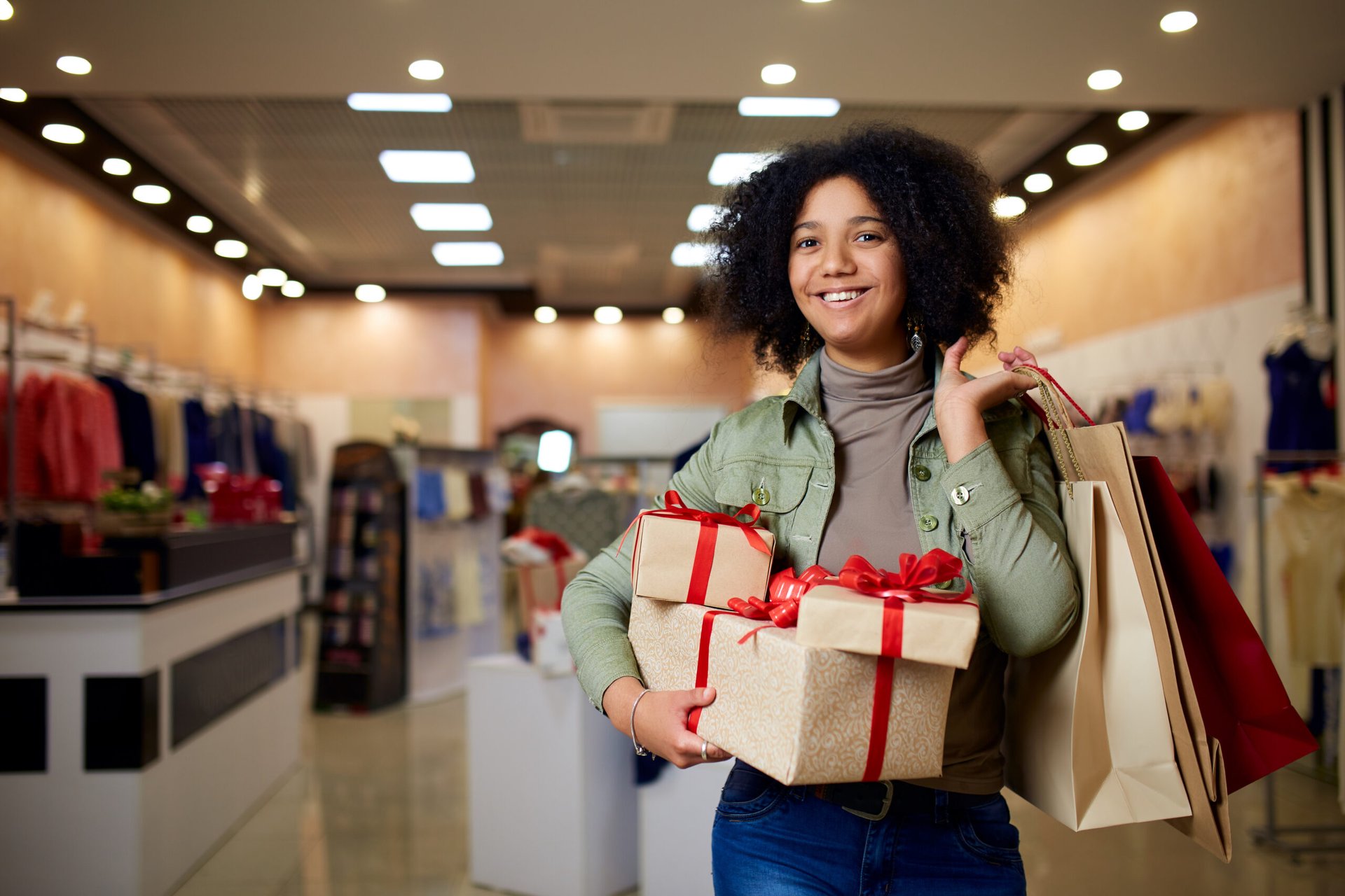 Woman with holiday gifts and shopping bags at a mall