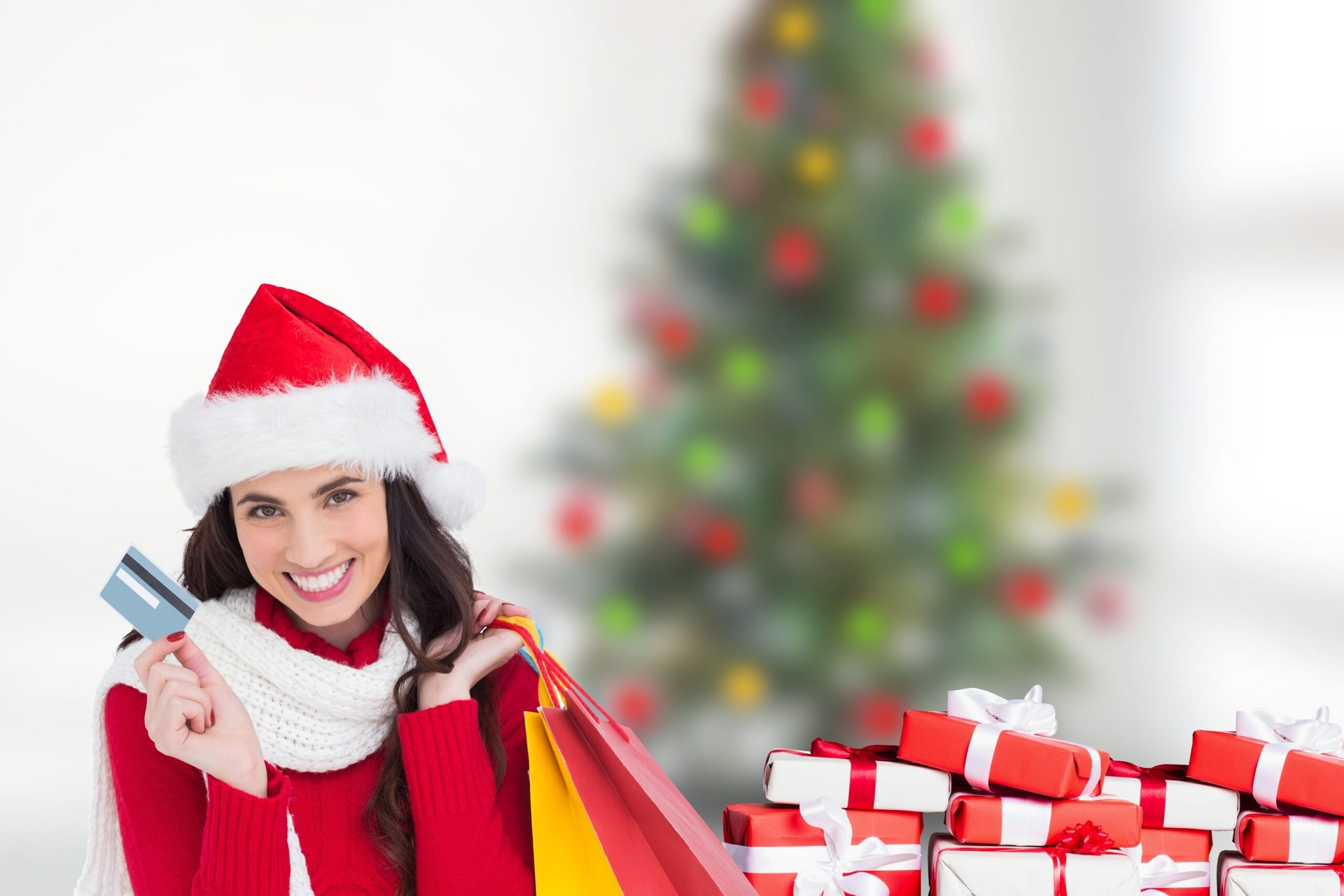 Happy Santa woman doing holiday shopping with gift cards