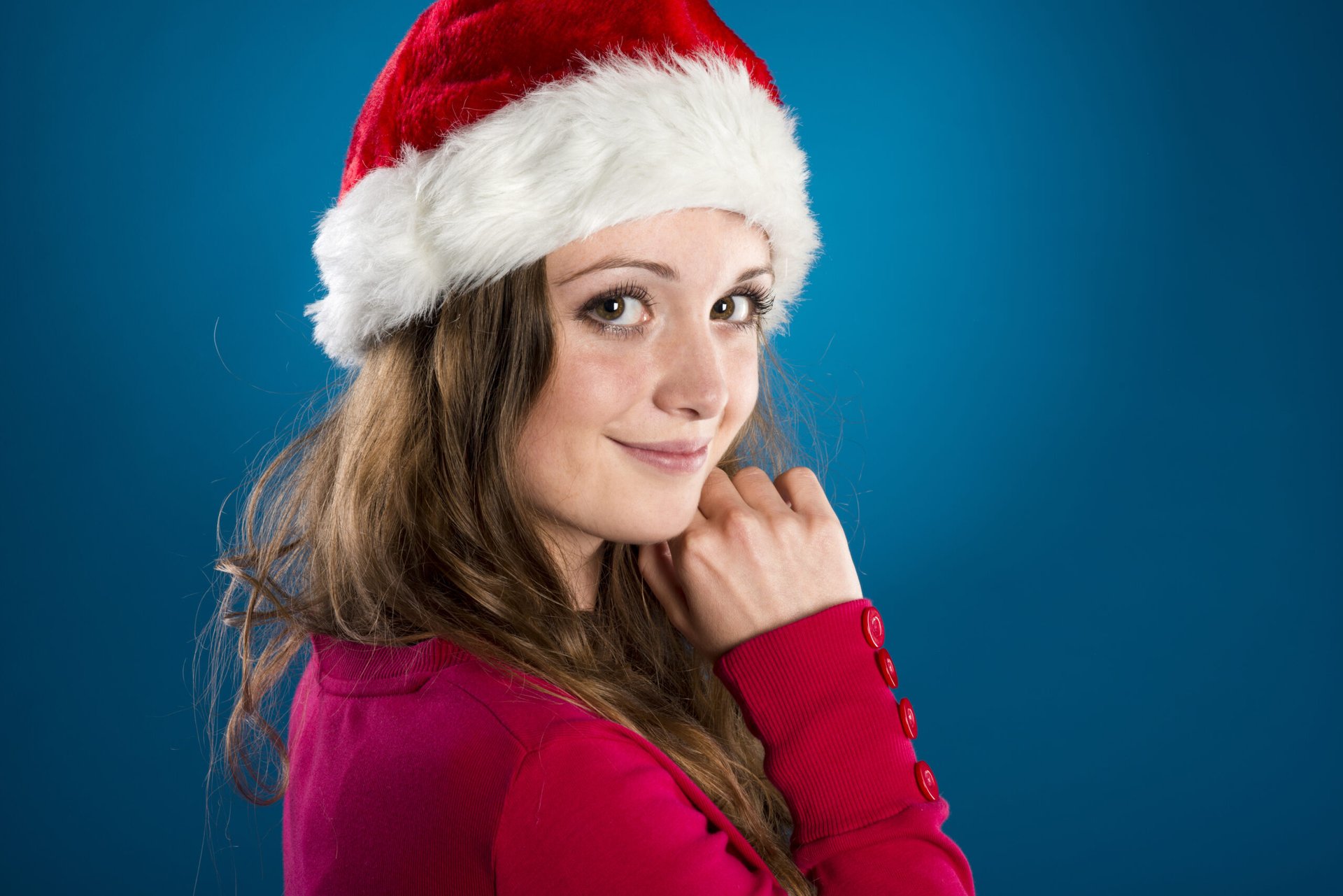 Happy woman in Santa hat at Christmas time