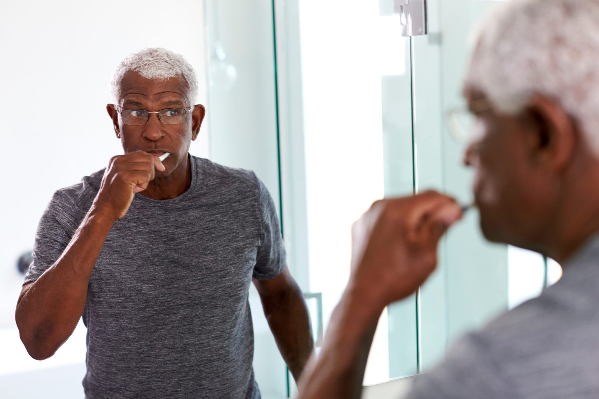 Senior man brushing teethSenior man brushing teeth