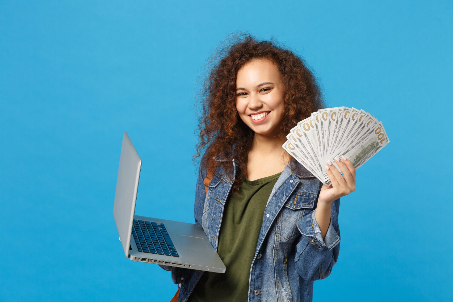 Teen girl with computer and money