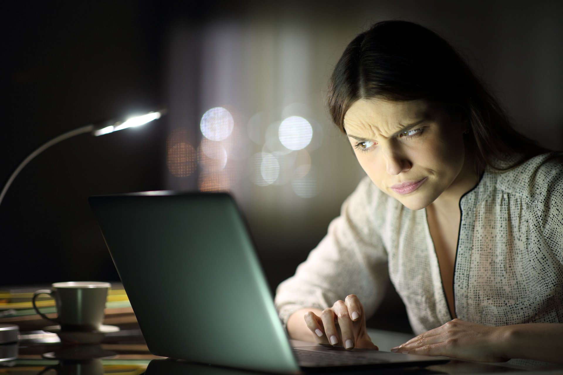 Suspicious woman at laptop