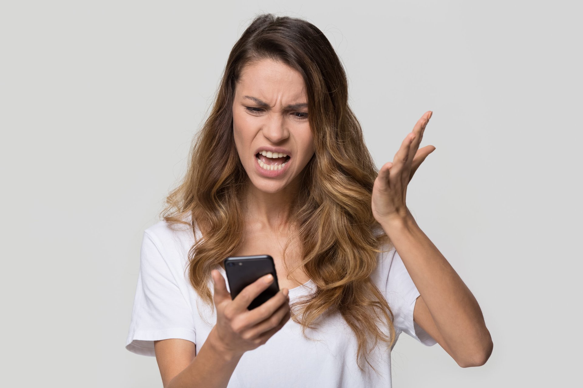 Angry woman looking at phone