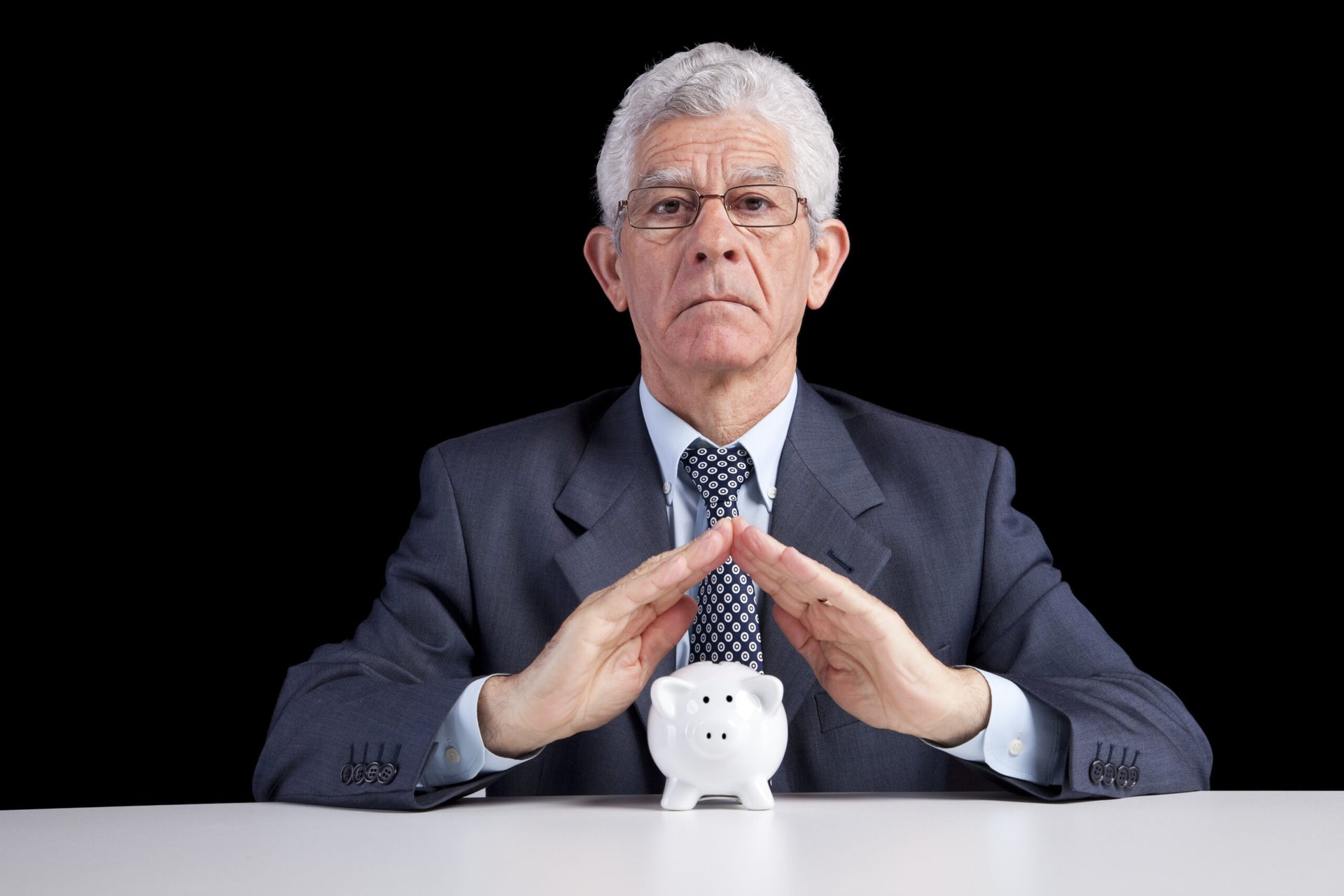 Senior businessman with piggy bank
