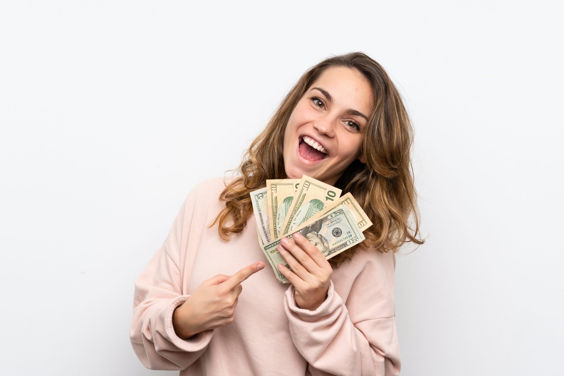 Happy woman pointing at money