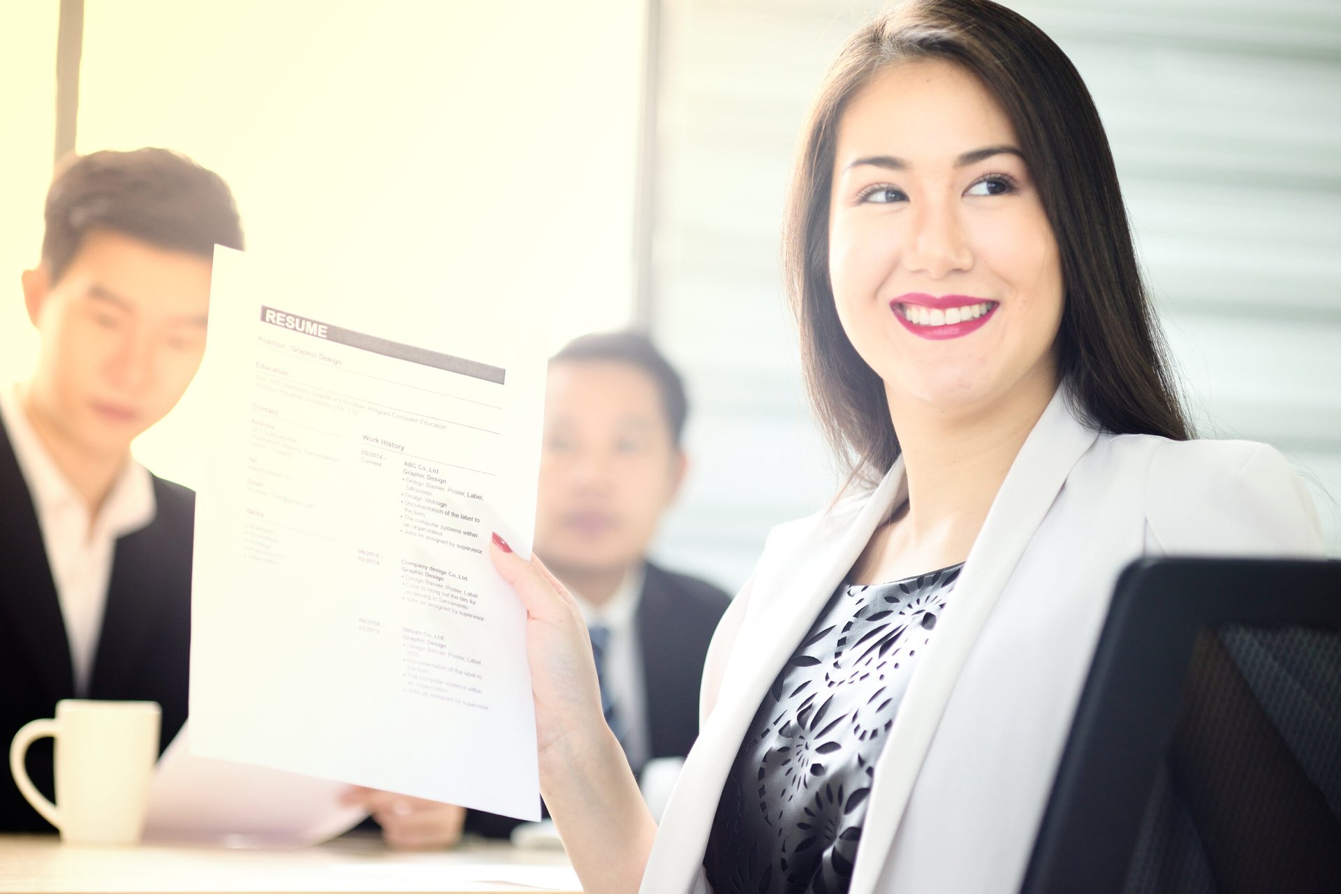 Employer showing resume to someone and smiling