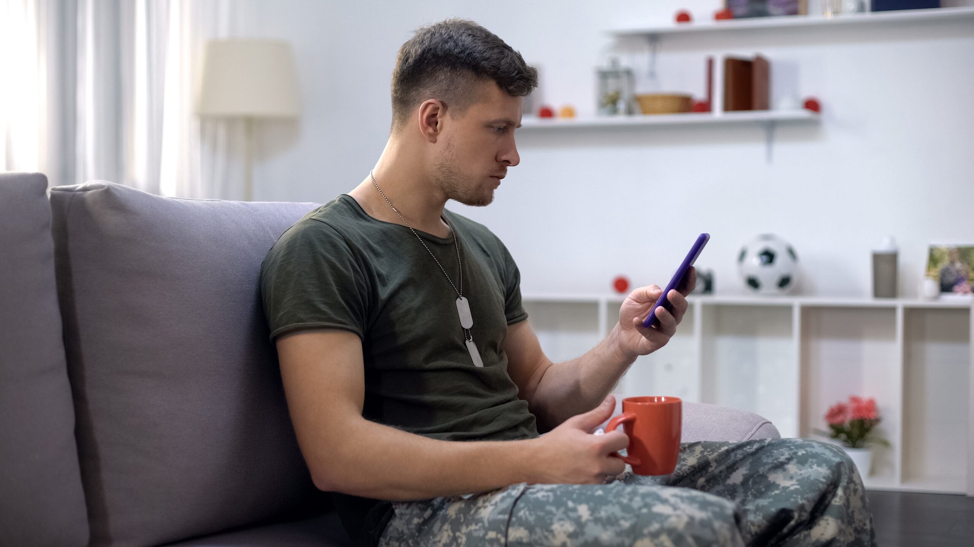 Military soldier or veteran using phone