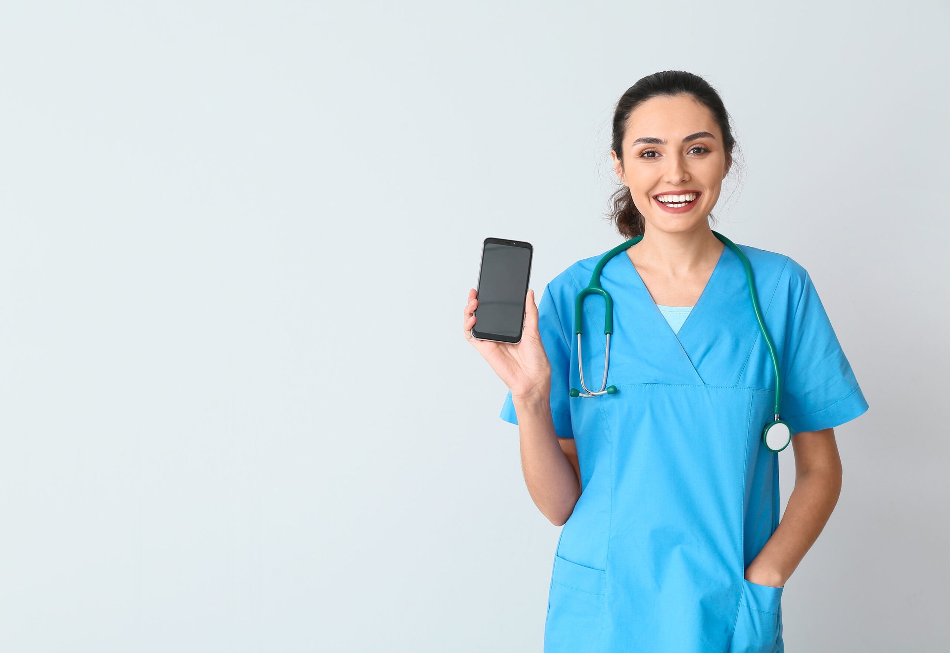 Female nurse with smartphone happy about discount