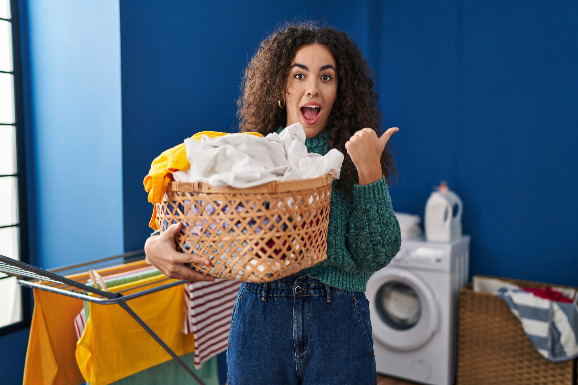 Happy woman holding laundry