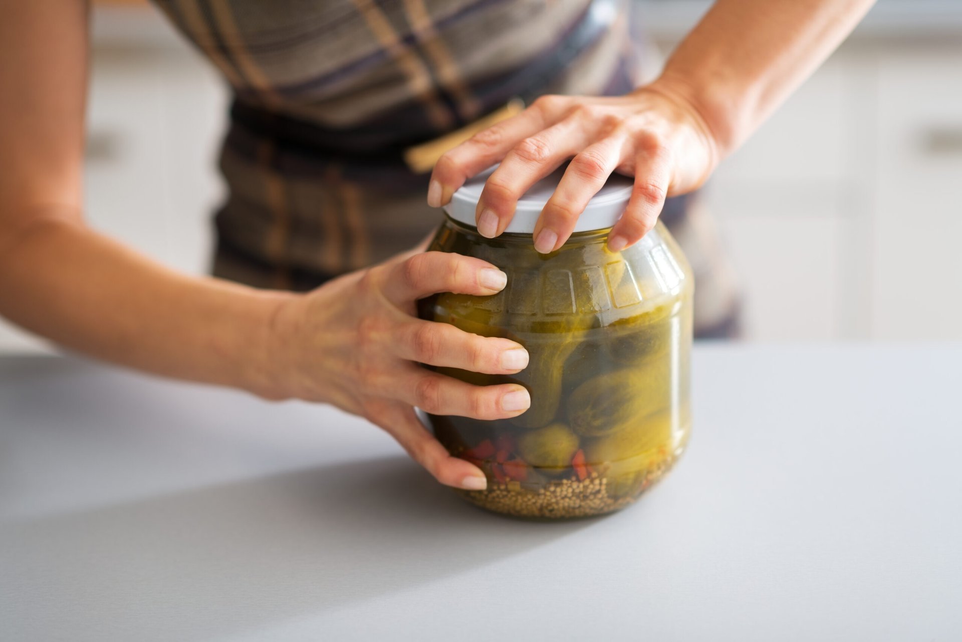 Woman opening a jar