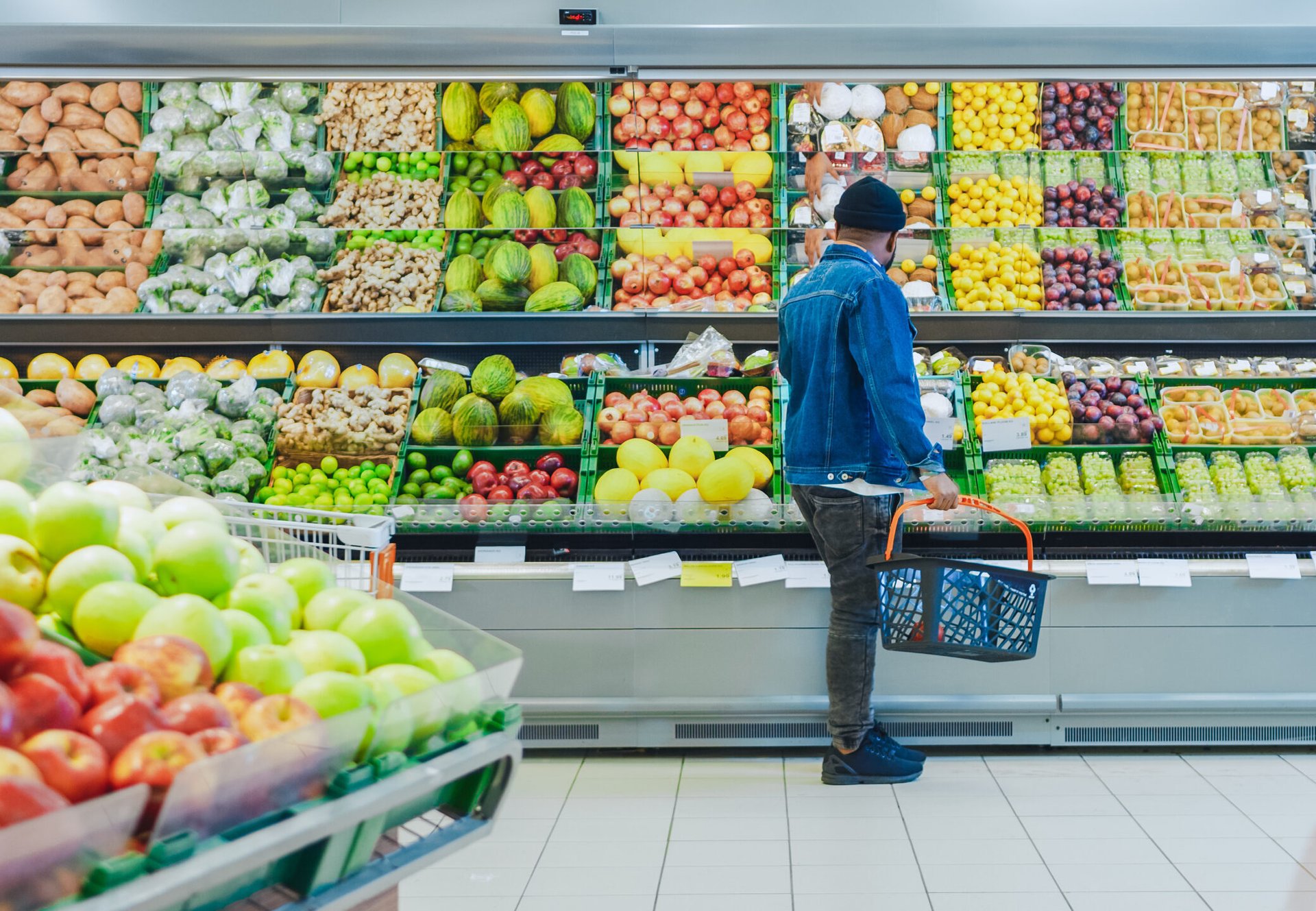 Shopper buying produce at a grocery store