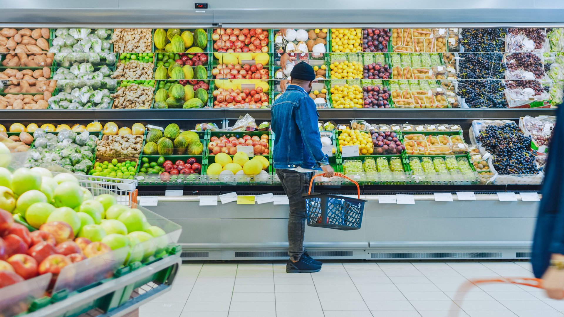 Shopper buying produce at a grocery store
