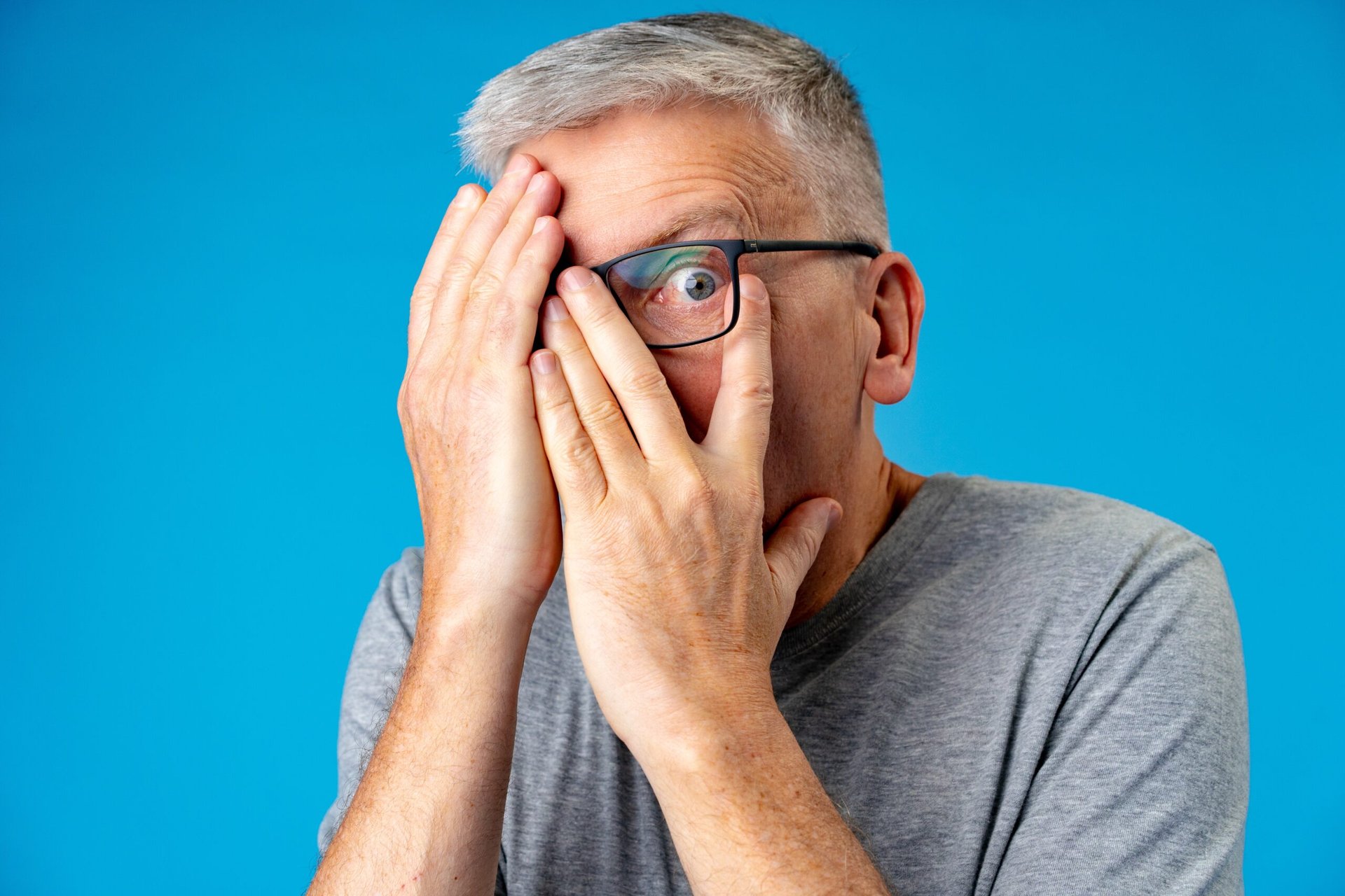 Panicked worried senior unable to look at something scary