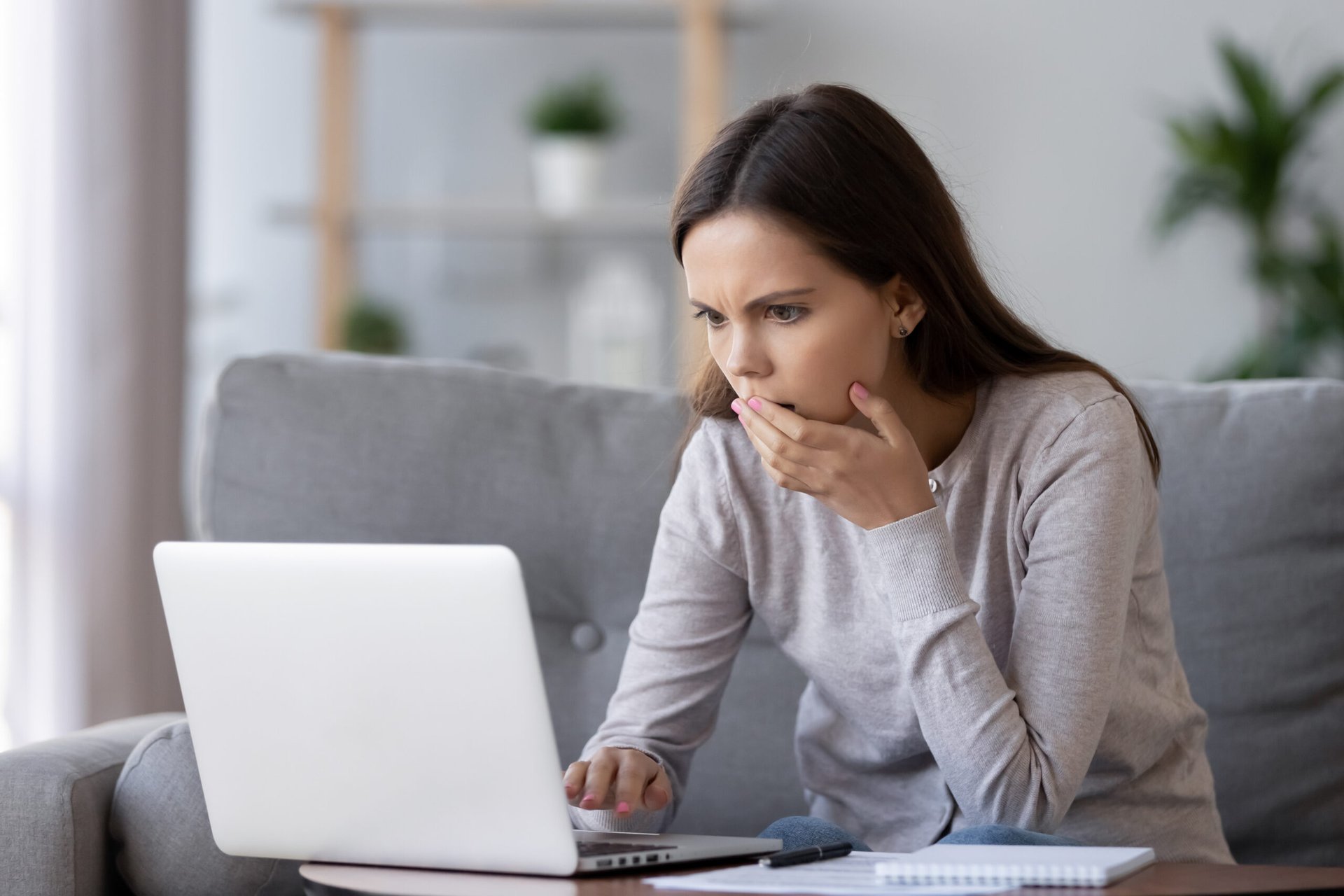 Woman shocked by something she's reading online