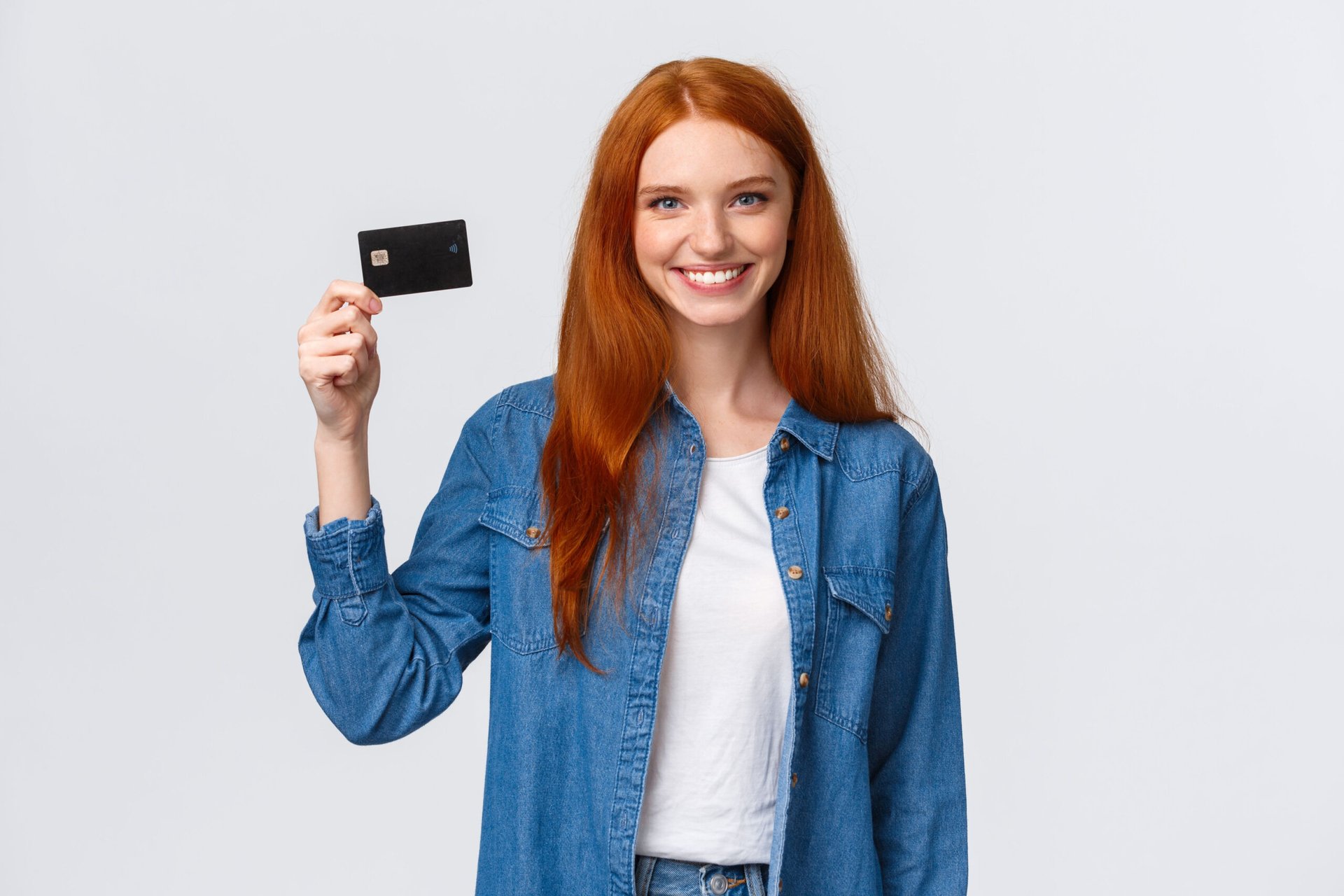 Young woman holding her first credit card for building credit