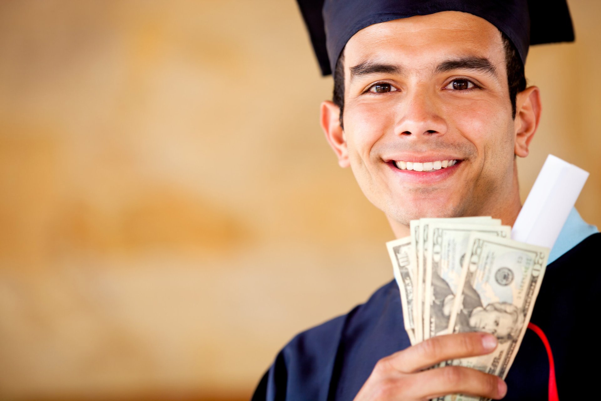 Recent college graduate holding money, specifically $20 bills in cash