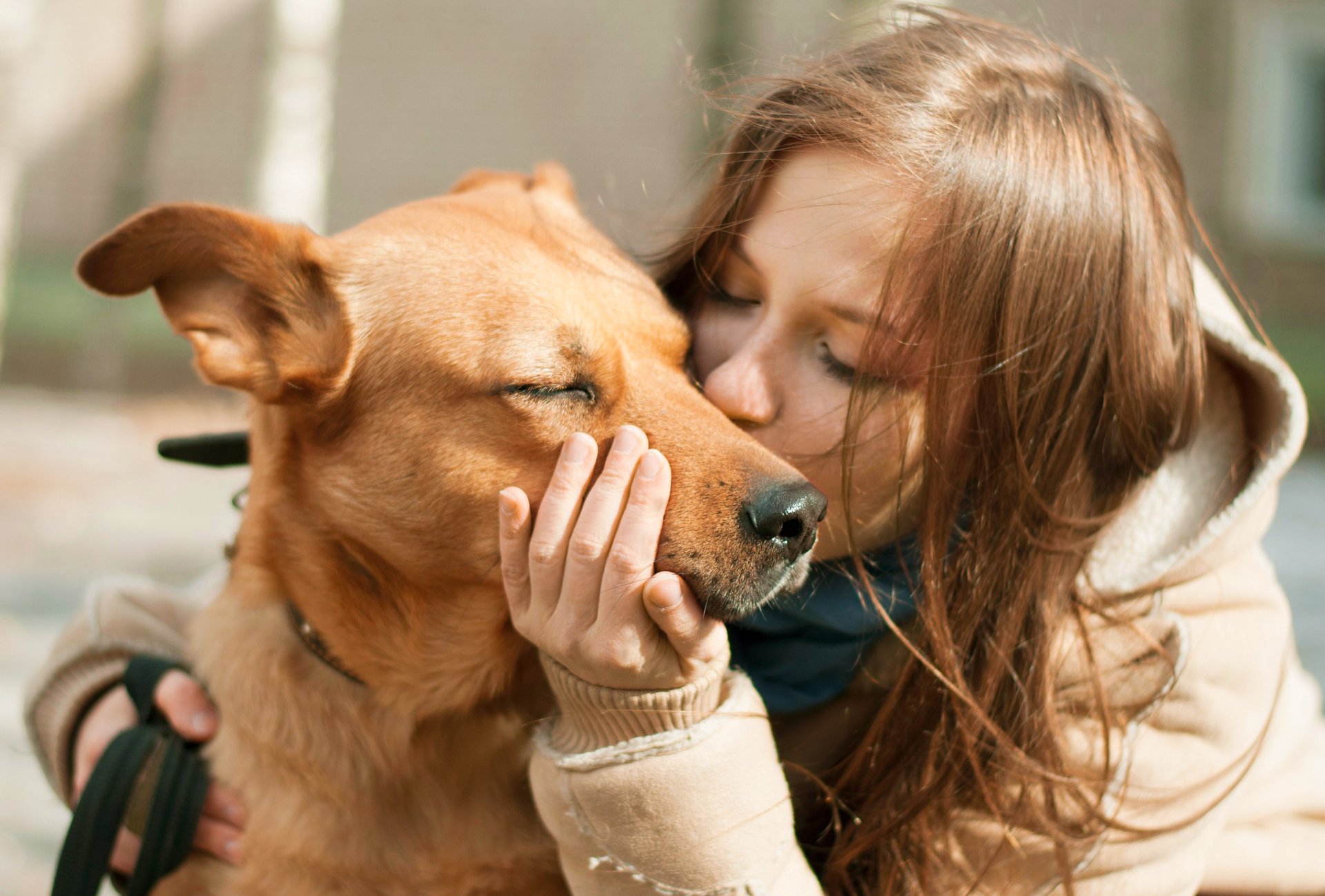 Woman kissing dog