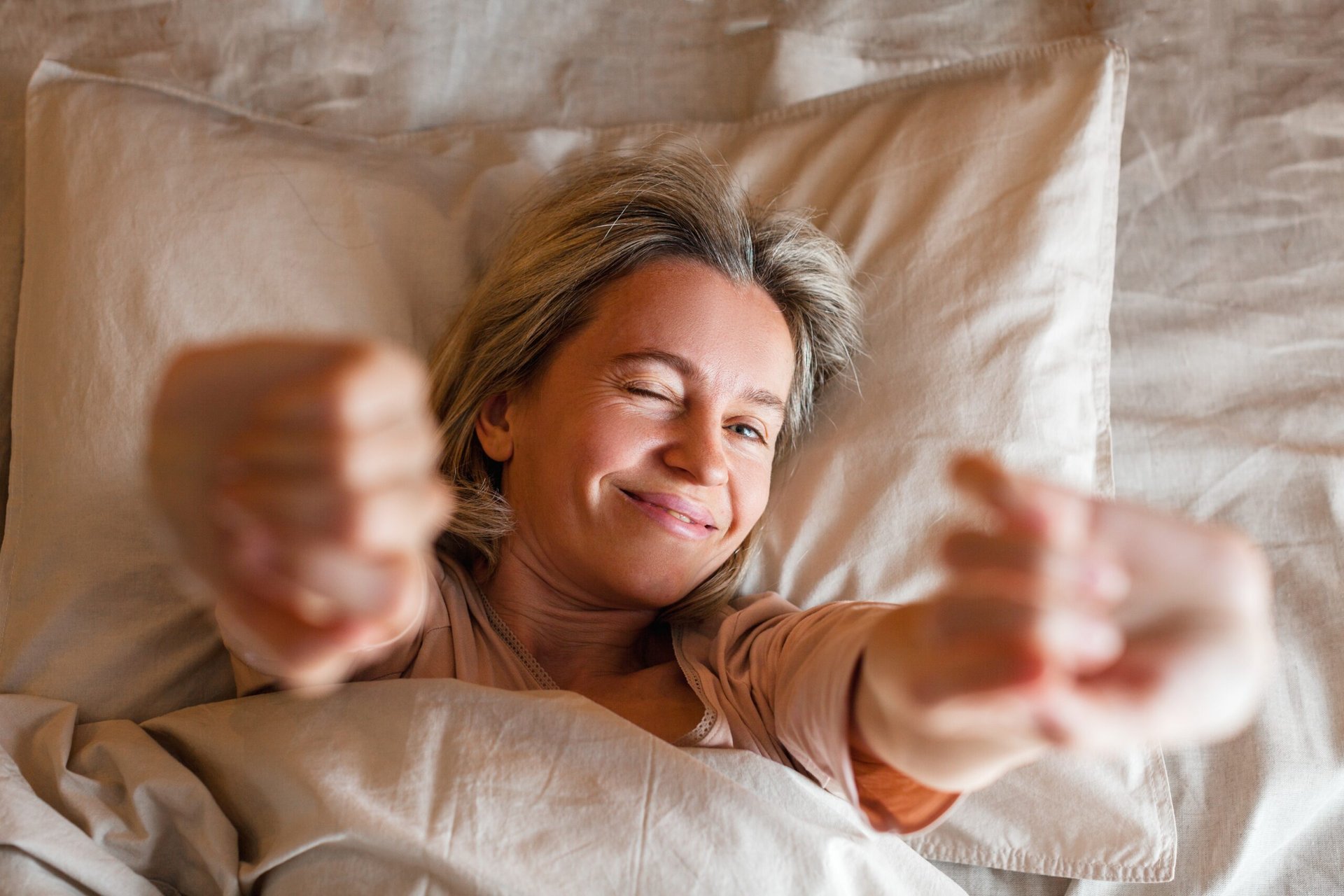 Happy, well-rested woman after sleep