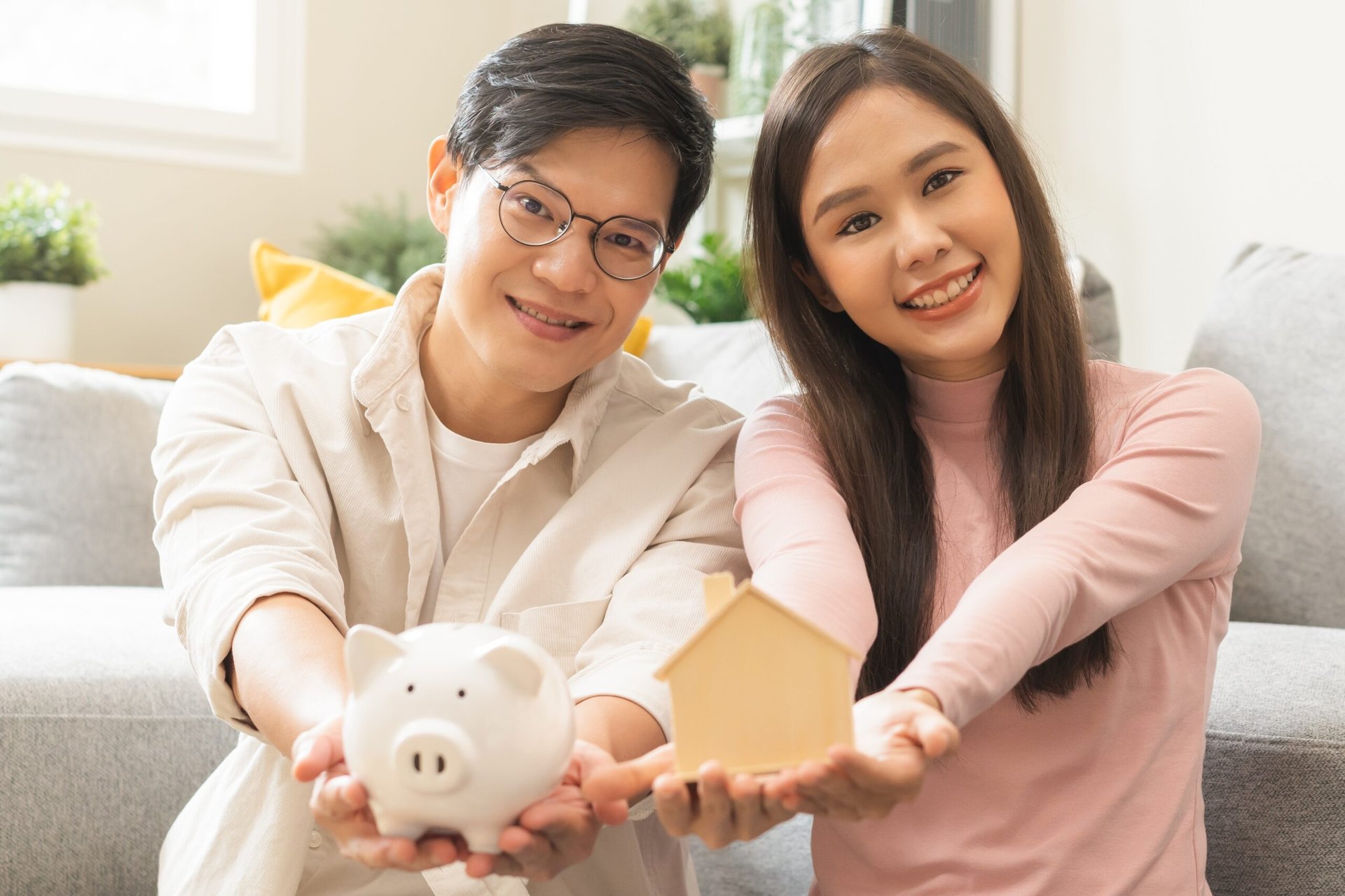 Happy young homeowners saving money