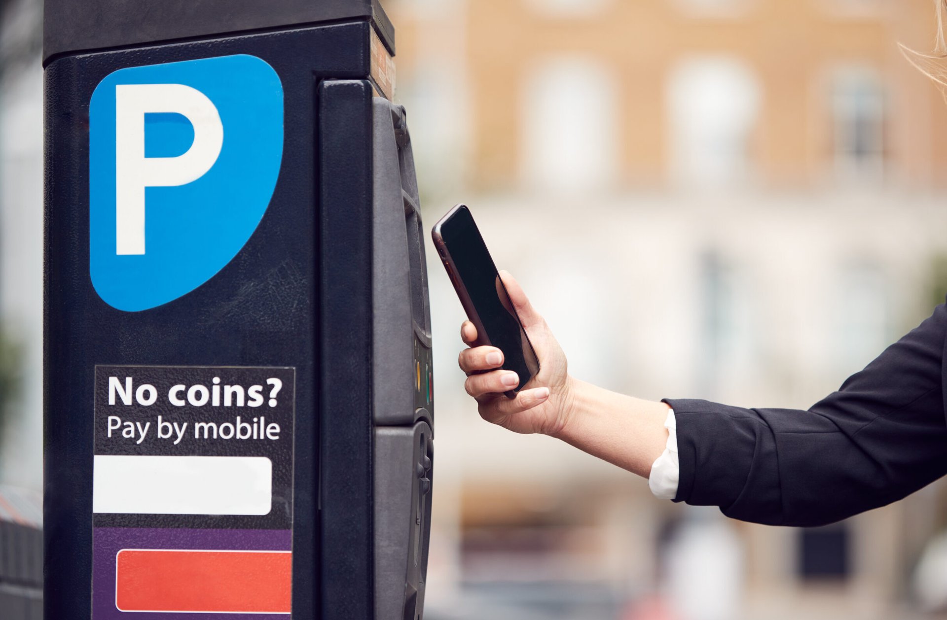 Person scanning a parking meter with a smartphone