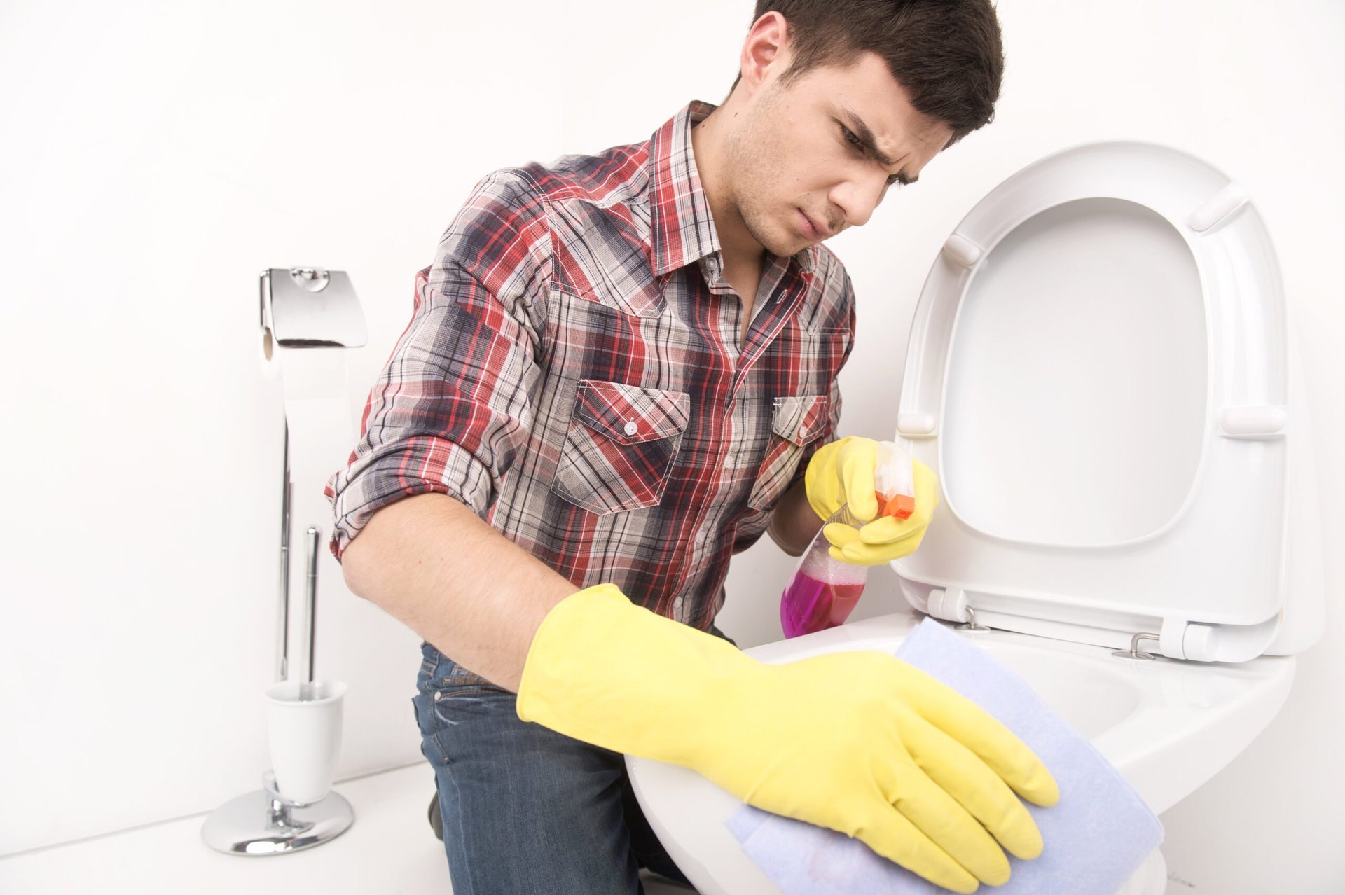 Man cleaning toilet.