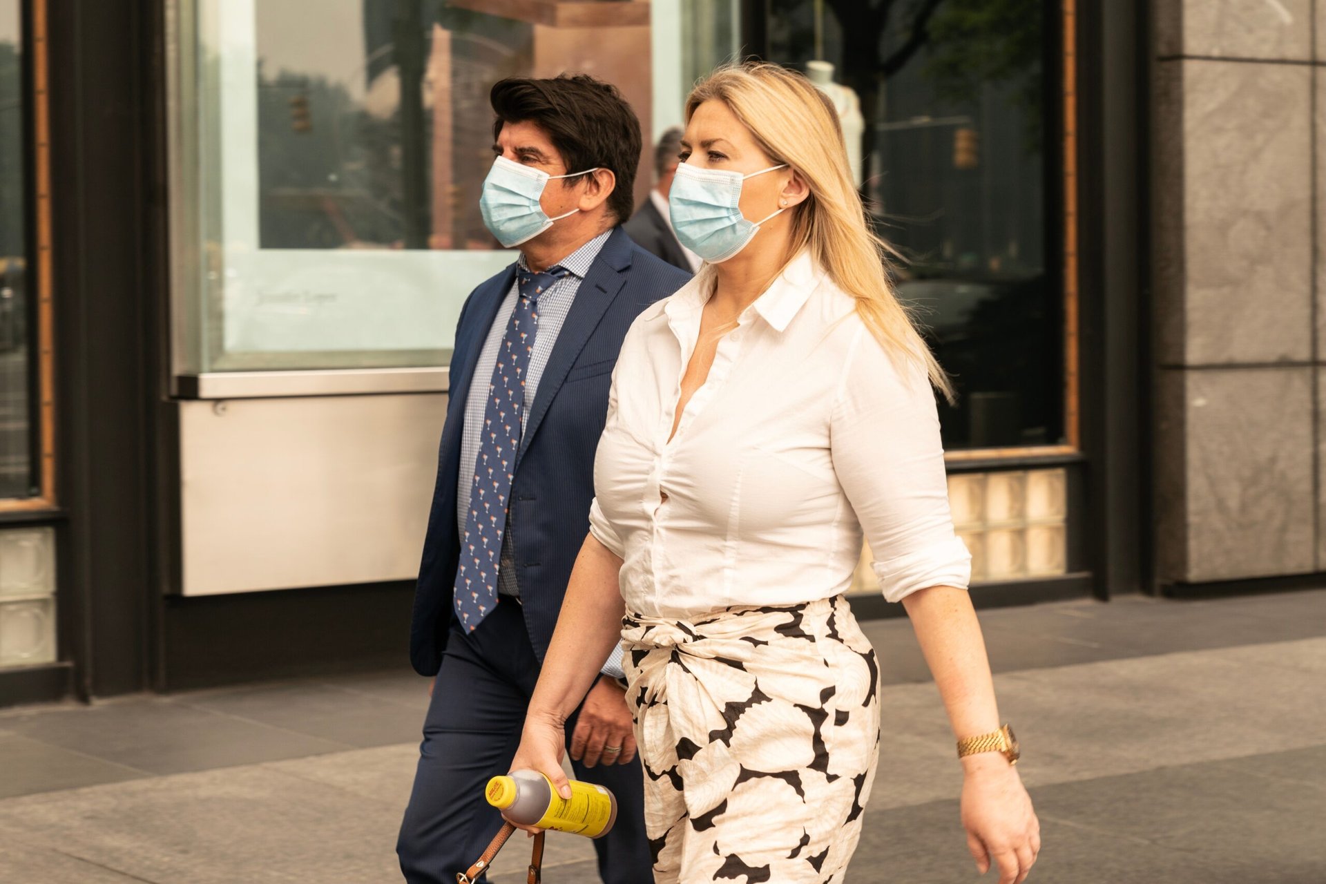 Two people wearing masks because of poor air quality.