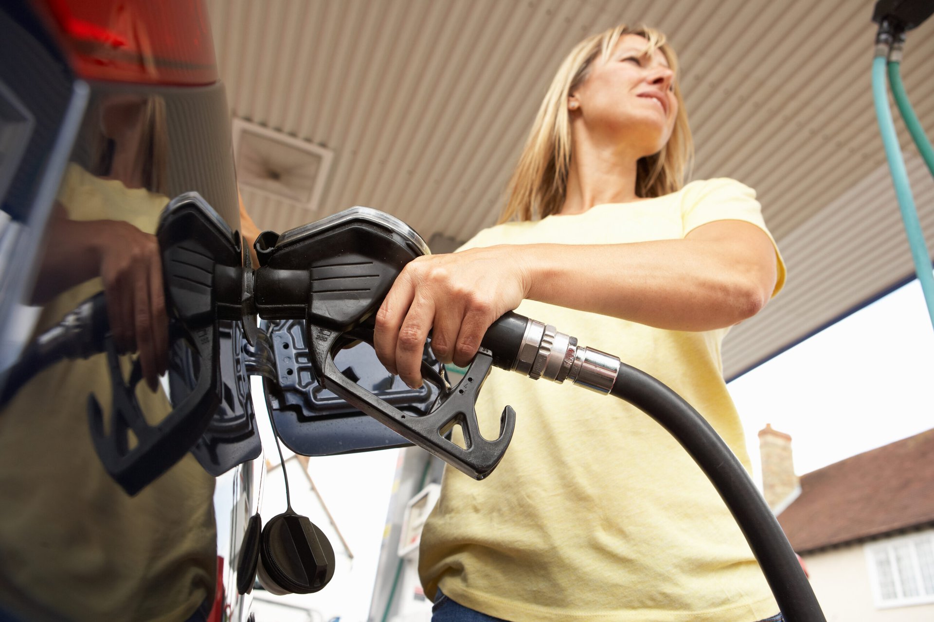 Woman filling up gas tank