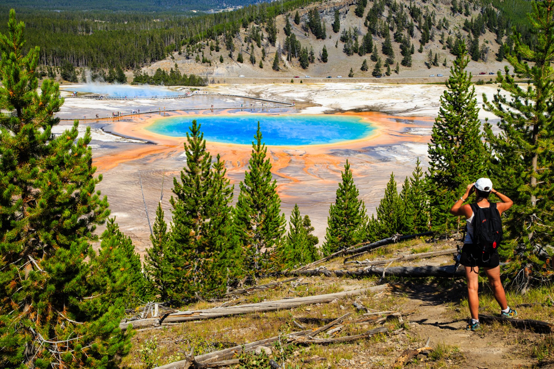 Hiker looking at Grand Prismatic Spring in Yellowstone National Park