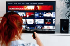 A woman watches Amazon Prime Video on TV at home