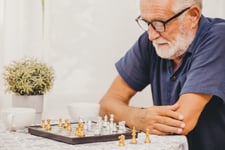 man plays board game to fight dementia