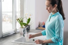 Woman filling a glass of water