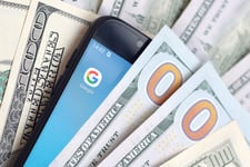 Google app on a smartphone and cash money