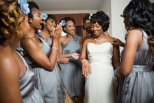 Bride and bridesmaids getting dressed.