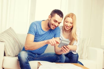 Happy couple with mortgage calculator